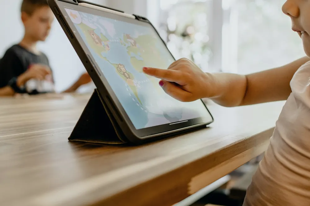 A child exploring a map on a tablet