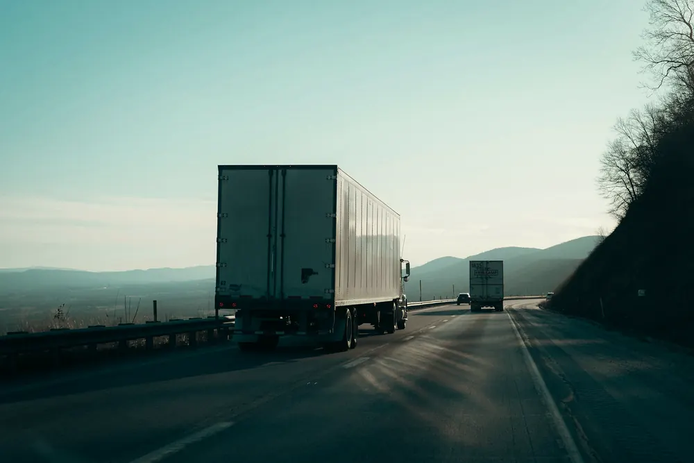 Trucks on a highway at dusk