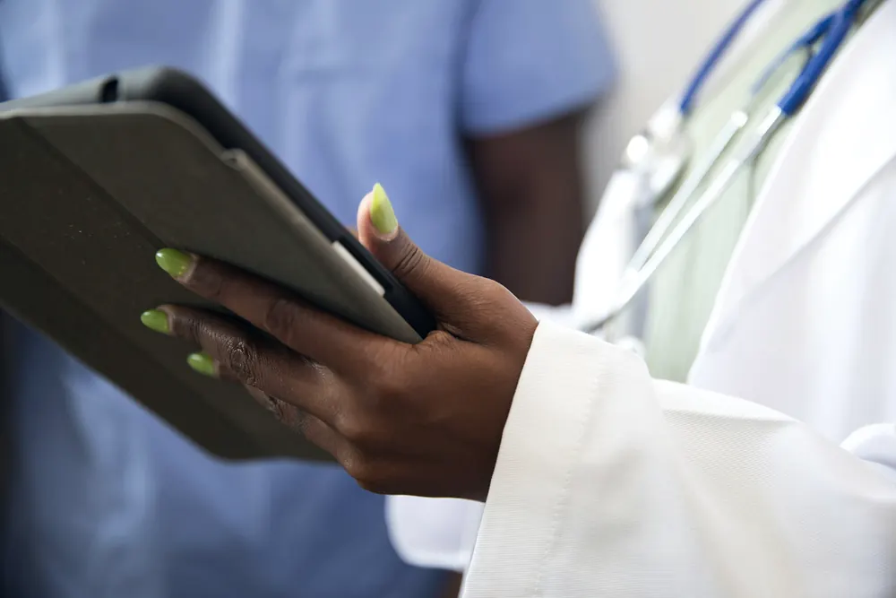 A clinician holding a tablet